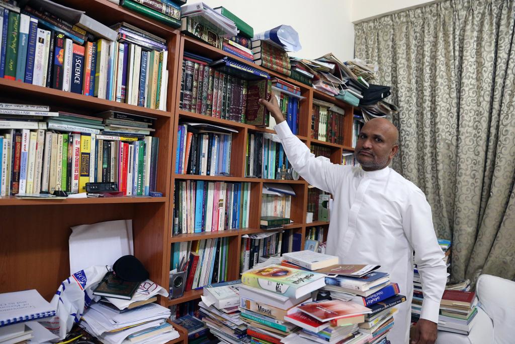 Abu Saleh with his books